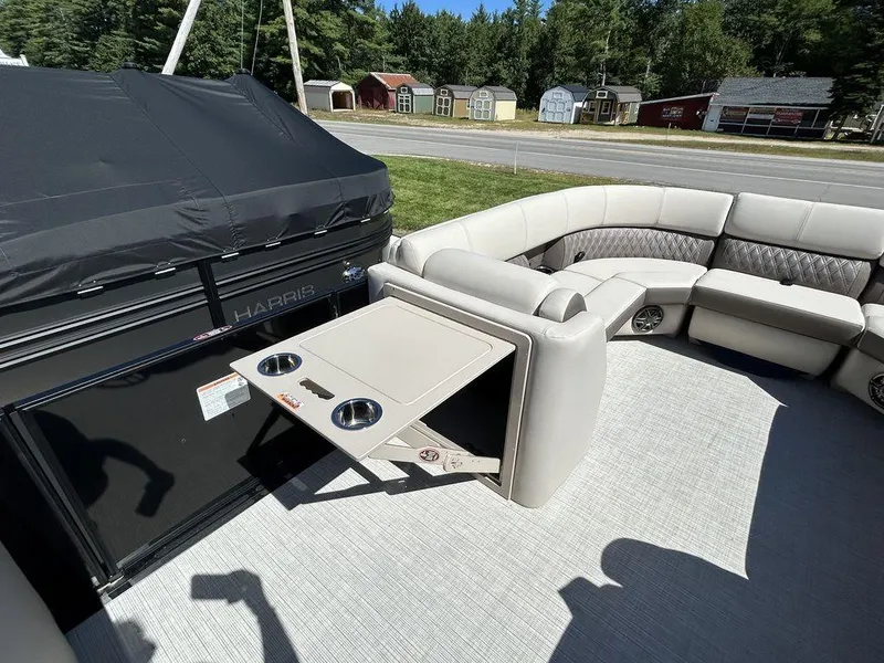 Slide: The Image of 2024 Harris Sunliner 230 pontoon boat interior with seating and foldable table. - 16