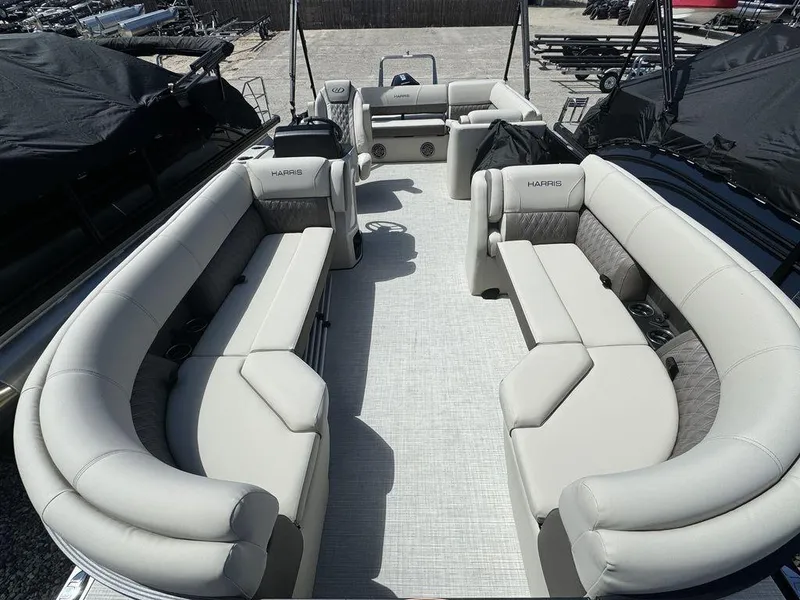 Slide: The Image of 2024 Harris Sunliner 230 pontoon boat with spacious seating and modern design. - 4