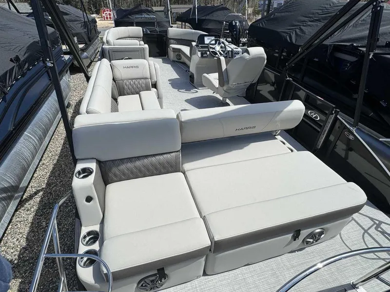 Slide: The Image of 2024 Harris Sunliner 230 pontoon boat with spacious seating and modern design. - 5