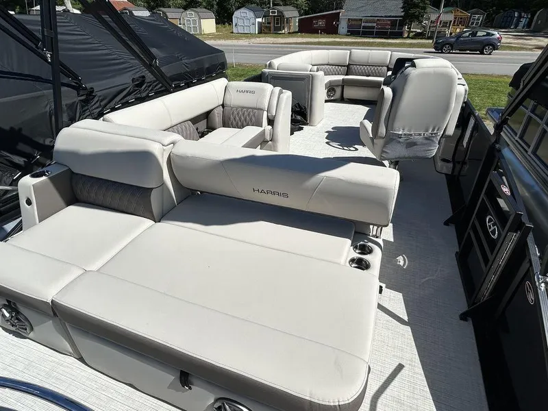 Slide: The Image of 2024 Harris Sunliner 230 pontoon boat with spacious seating and modern design. - 8