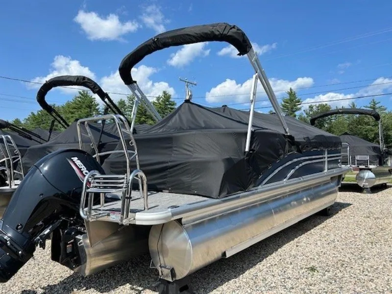 Slide: The Image of 2024 Harris Sunliner 210 pontoon boat with black cover and Mercury outboard motor. - 2