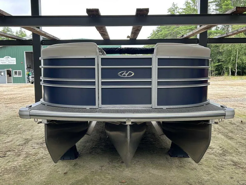 Slide: The Image of 2024 Harris Sunliner 210 pontoon boat in storage, front view. - 3