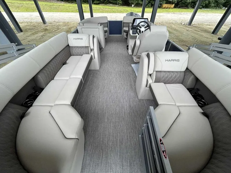 Slide: The Image of 2024 Harris Sunliner 210 pontoon boat interior with plush seating and modern design. - 6