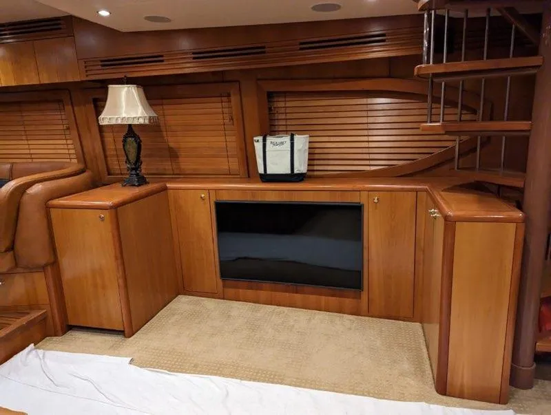 Slide: The Image of Interior of 2007 Hatteras 68 Convertible yacht with wooden cabinetry and spiral staircase. - 5