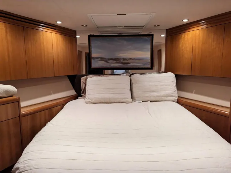 Slide: The Image of Luxurious bedroom in a 2007 Hatteras 68 Convertible yacht with wood cabinetry. - 9