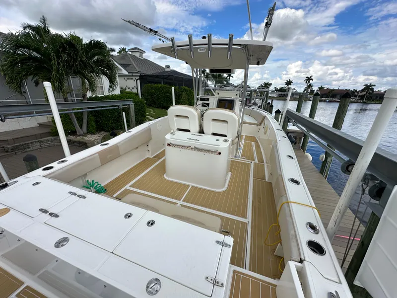 Slide: The Image of 2014 Stamas 317 Tarpon boat docked, featuring spacious deck and seating. - 11