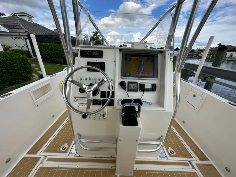 Slide: The Image of 2014 Stamas 317 Tarpon boat console with steering wheel and navigation system. - 13