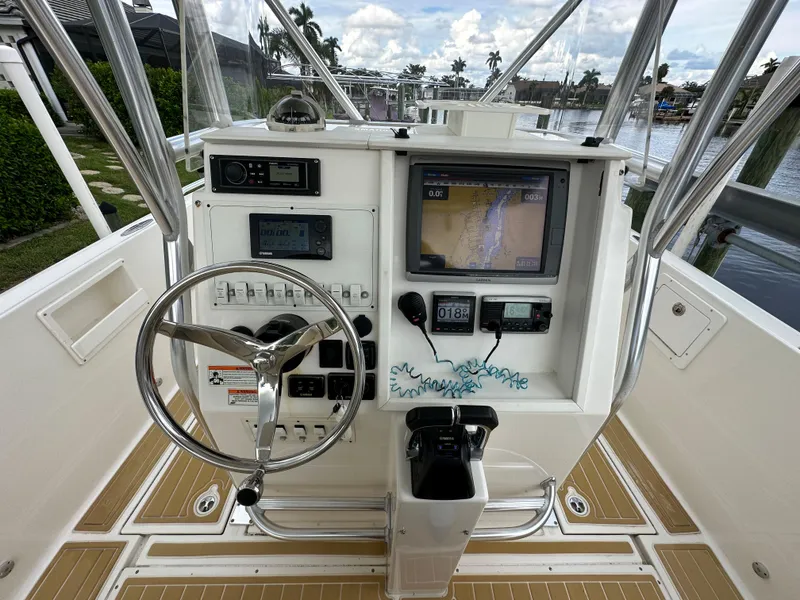 Slide: The Image of 2014 Stamas 317 Tarpon boat console with steering wheel, navigation system, and controls. - 15