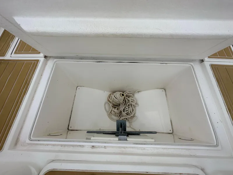 Slide: The Image of Open storage compartment on a 2014 Stamas 317 Tarpon boat with coiled rope inside. - 23
