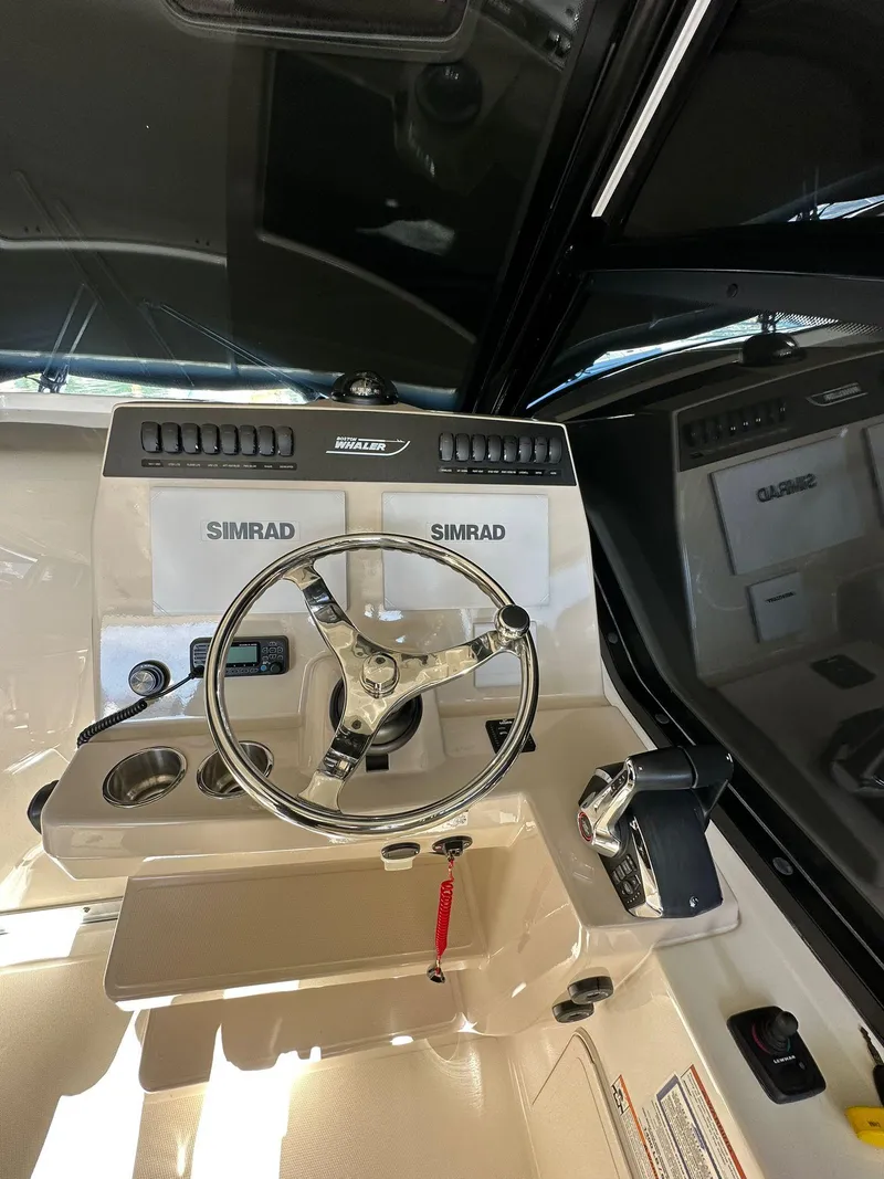 Slide: The Image of 2023 Boston Whaler 325 Conquest helm with Simrad electronics and modern steering wheel. - 13
