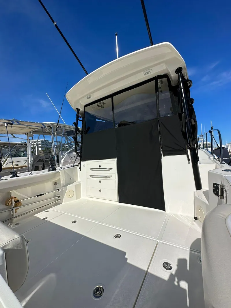 Slide: The Image of 2023 Boston Whaler 325 Conquest boat deck with clear blue sky background. - 5