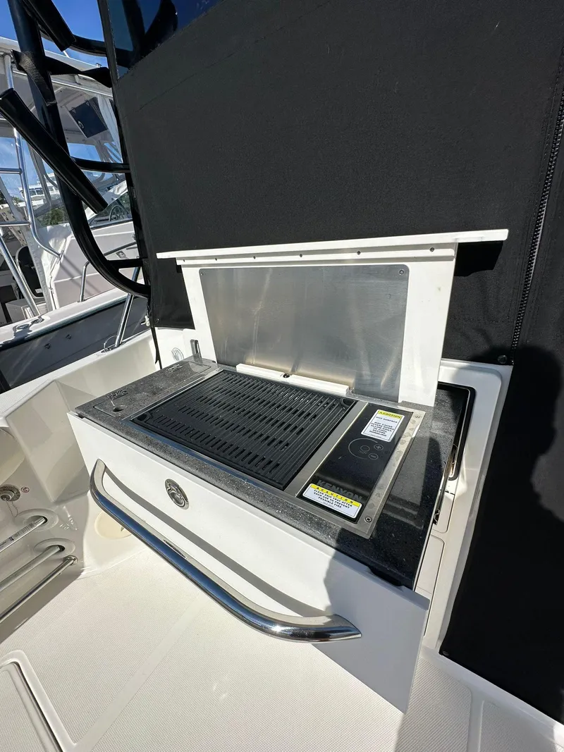 Slide: The Image of Outdoor grill on 2023 Boston Whaler 325 Conquest boat deck. - 6