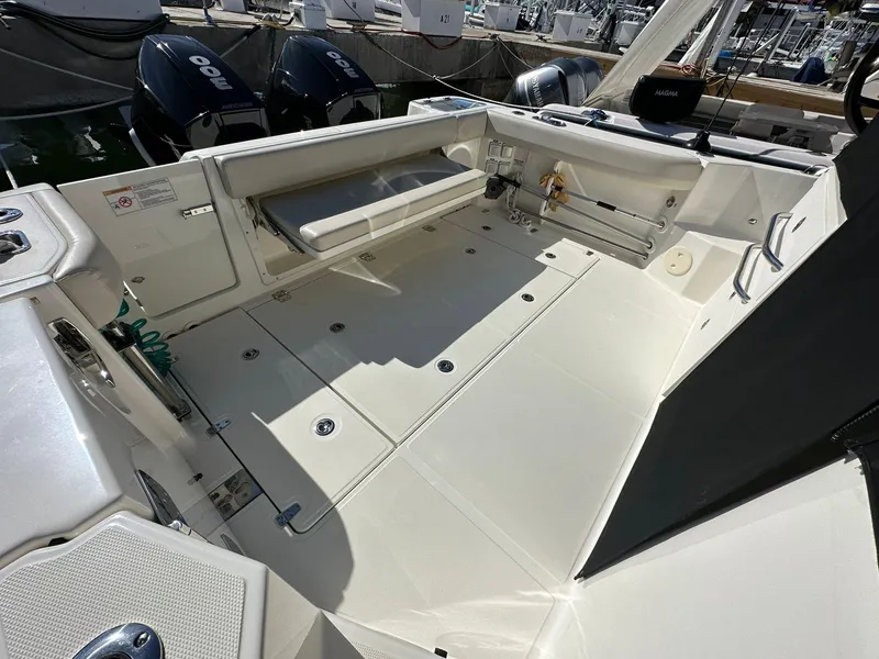 Slide: The Image of 2023 Boston Whaler 325 Conquest boat deck with seating and storage compartments. - 7
