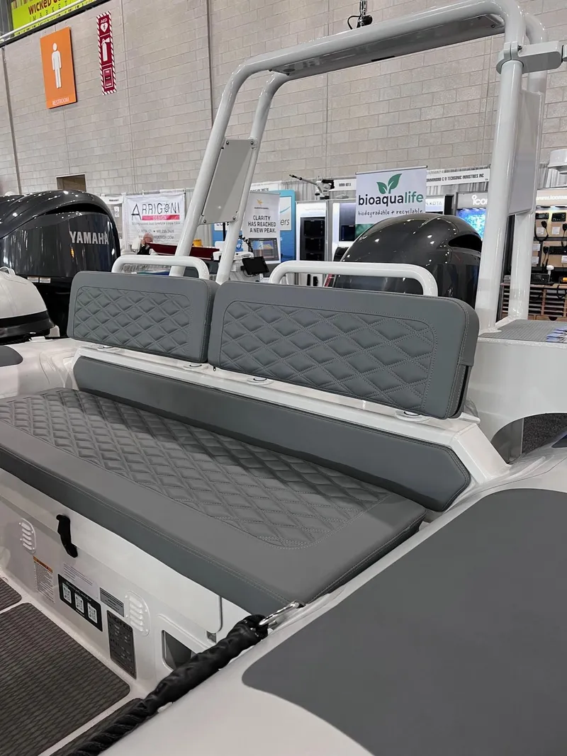 Slide: The Image of 2024 Highfield Patrol 600 boat interior with gray cushioned seating. - 3
