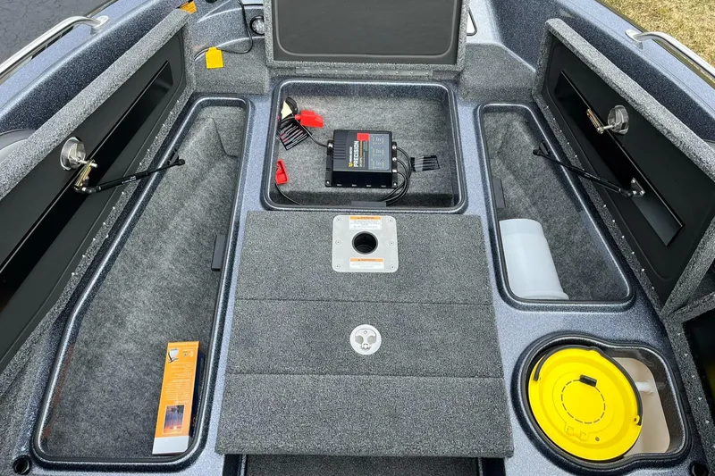 Slide: The Image of 2024 Lund 189 Tyee GL boat interior with storage compartments and equipment. - 11
