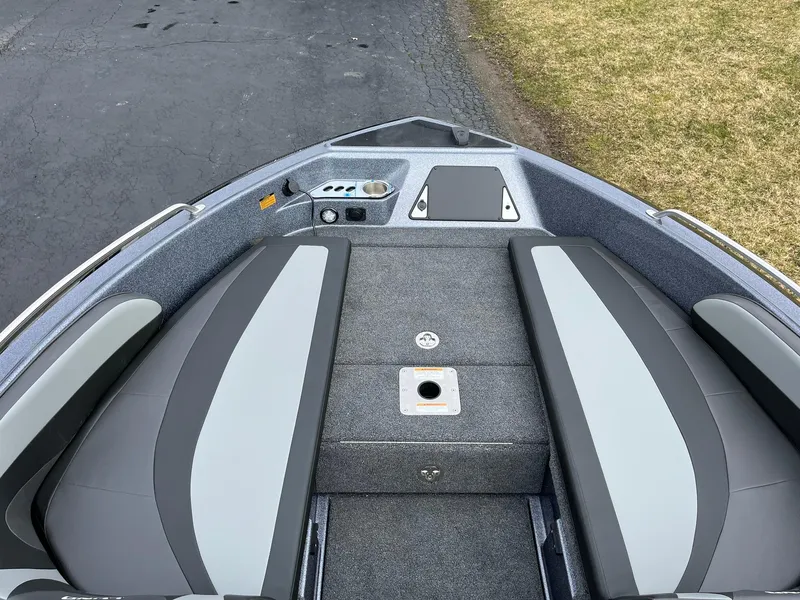 Slide: The Image of 2024 Lund 189 Tyee GL boat interior with gray seating and storage compartments. - 12