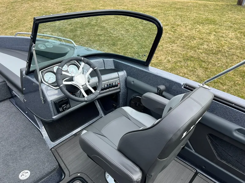 Slide: The Image of 2024 Lund 189 Tyee GL boat interior with steering wheel and dashboard. - 17