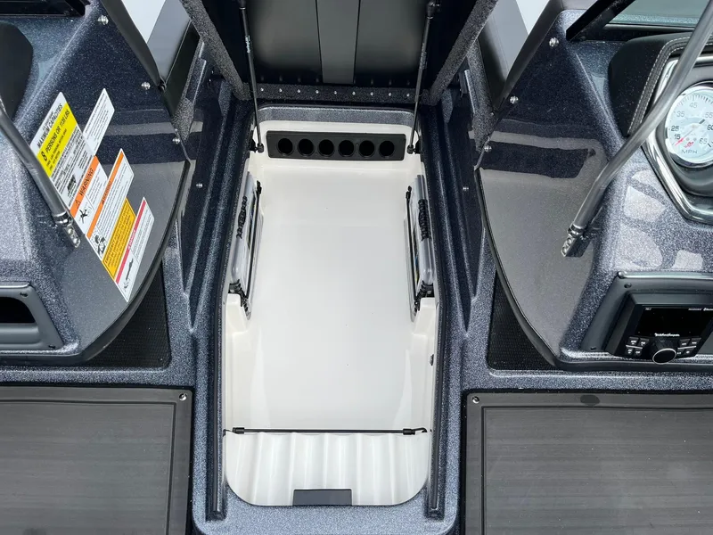 Slide: The Image of 2024 Lund 189 Tyee GL boat interior with storage compartment and control panel. - 19