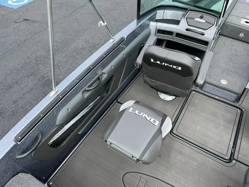 Slide: The Image of 2024 Lund 189 Tyee GL boat interior with branded seating and sleek design. - 21