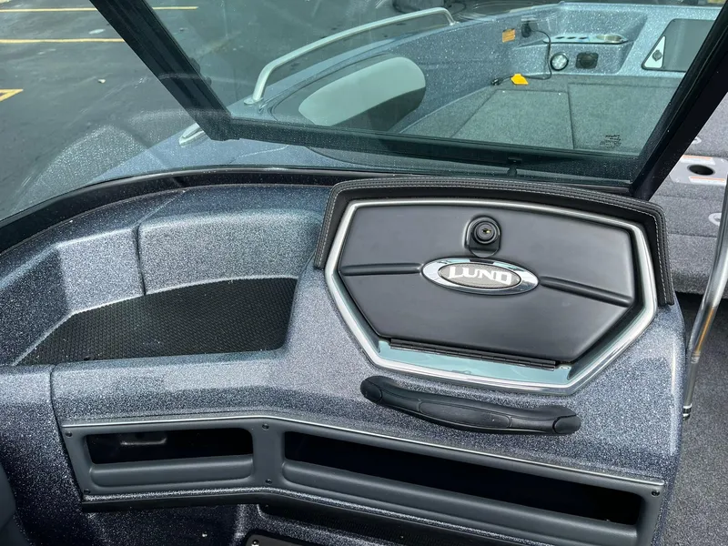 Slide: The Image of 2024 Lund 189 Tyee GL boat dashboard with windshield and storage compartment. - 22