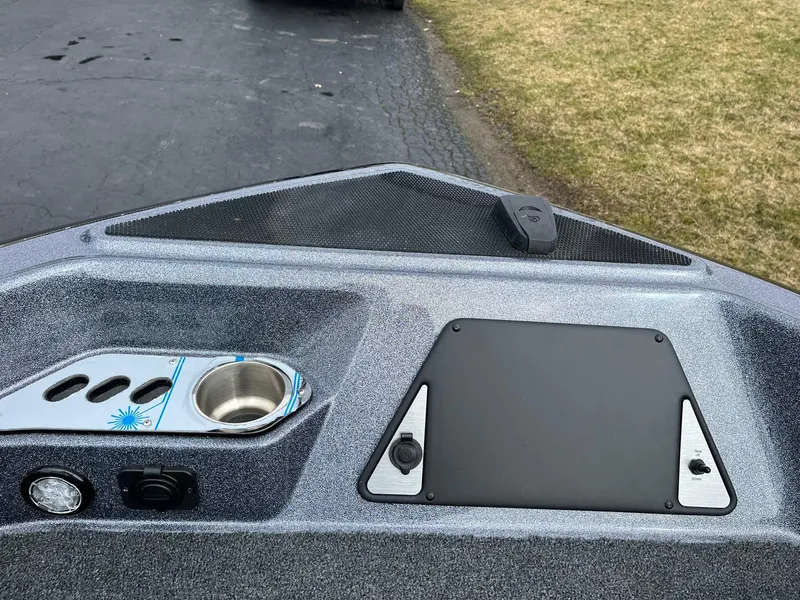 Slide: The Image of 2024 Lund 189 Tyee GL boat dashboard with cup holder and control panel. - 23