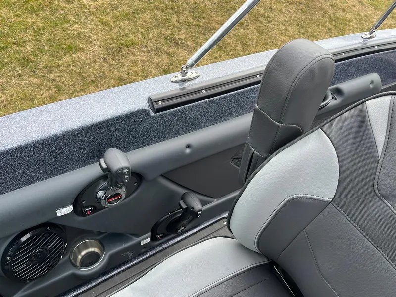 Slide: The Image of 2024 Lund 189 Tyee GL boat interior with gray seating and control panel. - 24