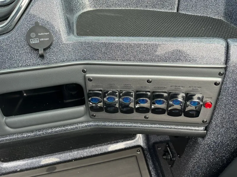 Slide: The Image of Control panel of 2024 Lund 189 Tyee GL boat with switches and USB port. - 25