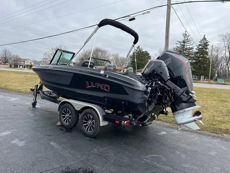 Slide: The Image of 2024 Lund 189 Tyee GL boat on trailer, parked outdoors. - 3