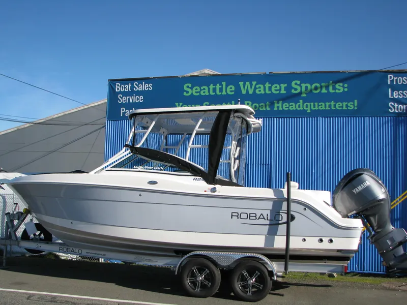 Slide: The Image of 2023 Robalo R247 Dual Console boat at Seattle Water Sports dealership. - 2