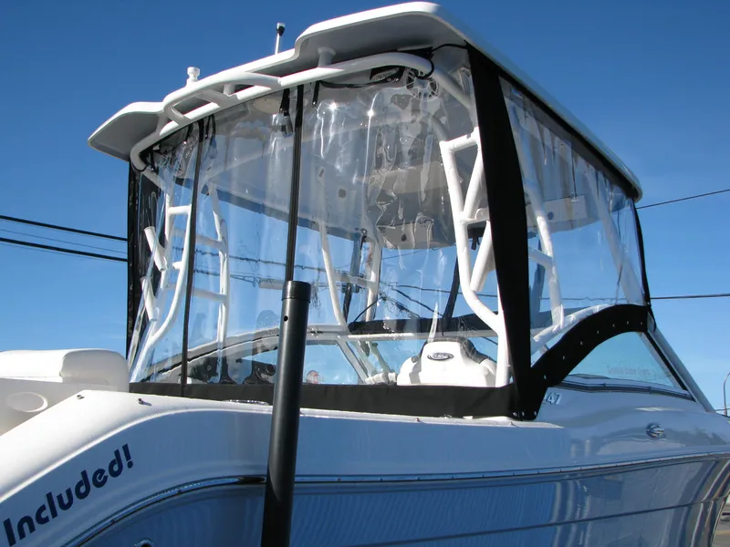 Slide: The Image of 2023 Robalo R247 Dual Console boat with clear enclosure. - 3