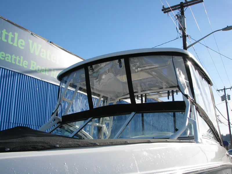 Slide: The Image of 2023 Robalo R247 Dual Console boat with clear windshield and black trim. - 4