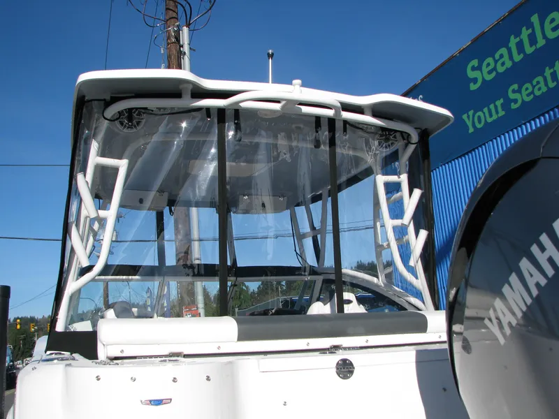 Slide: The Image of 2023 Robalo R247 Dual Console boat with Yamaha engine, rear view. - 6