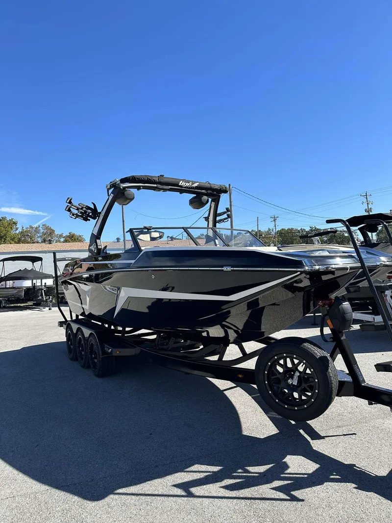 The Image of 2024 Tigé 24RZX boat on a trailer under a clear blue sky. - 0