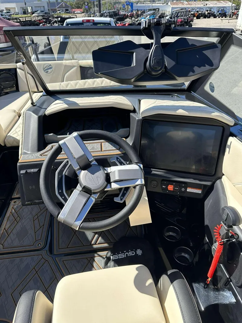 Slide: The Image of 2024 Tigé 24RZX boat dashboard with modern steering wheel and touchscreen display. - 14