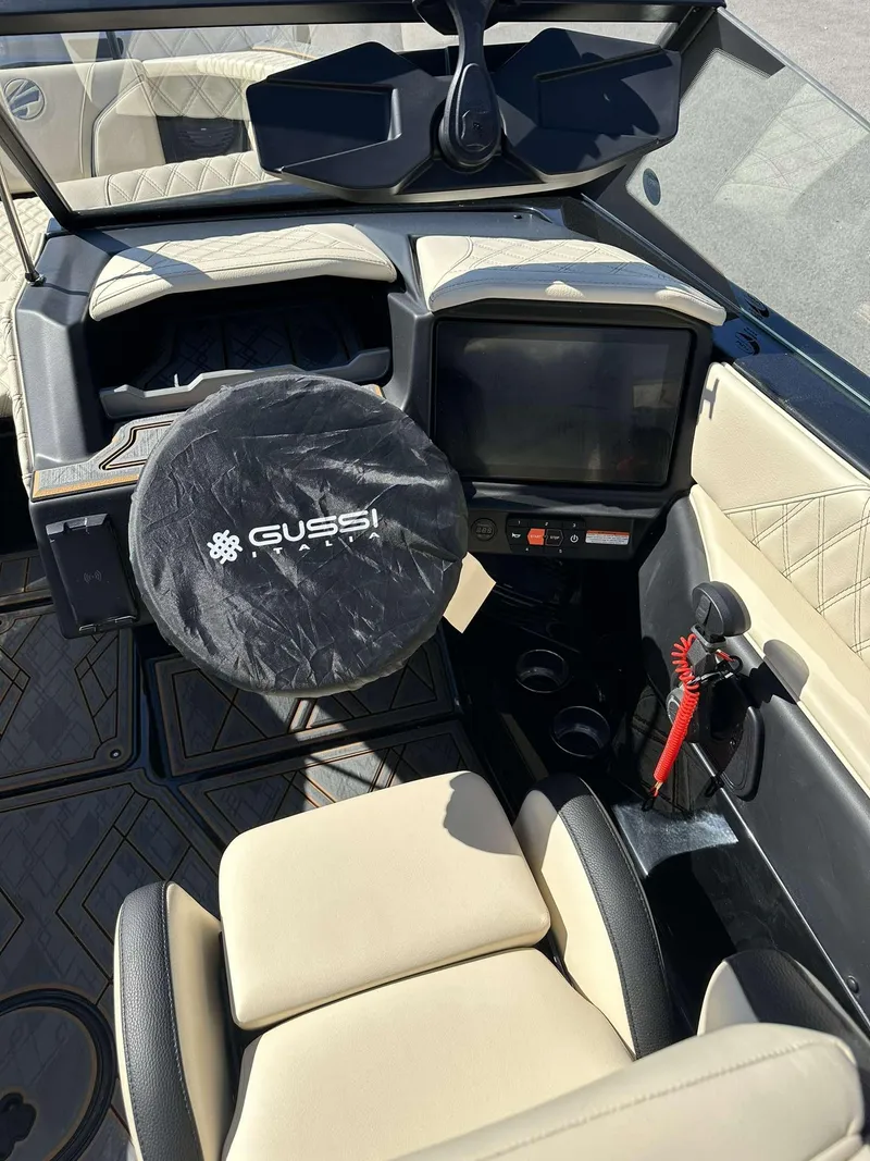 Slide: The Image of 2024 Tigé 24RZX boat cockpit with Gussi steering wheel cover and modern dashboard. - 16