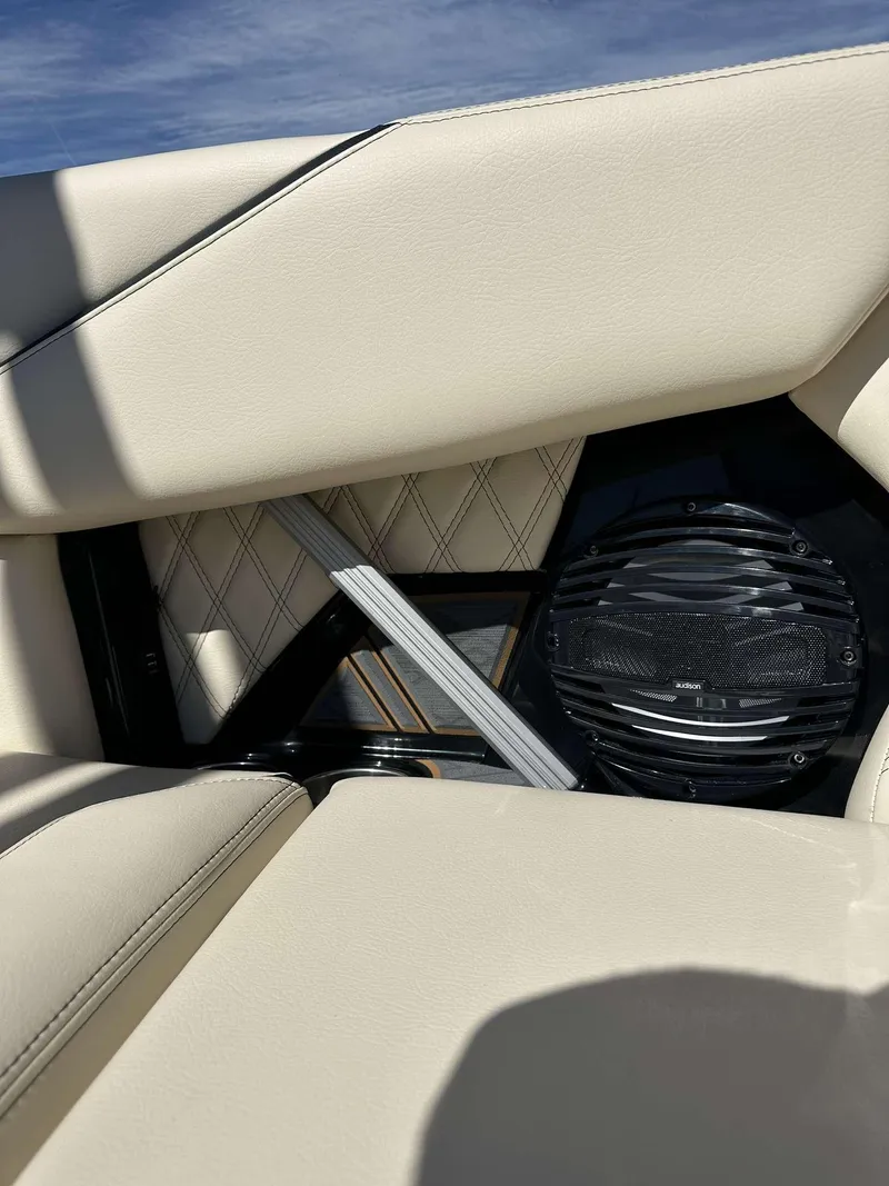 Slide: The Image of 2024 Tigé 24RZX boat interior with beige upholstery and speaker. - 17