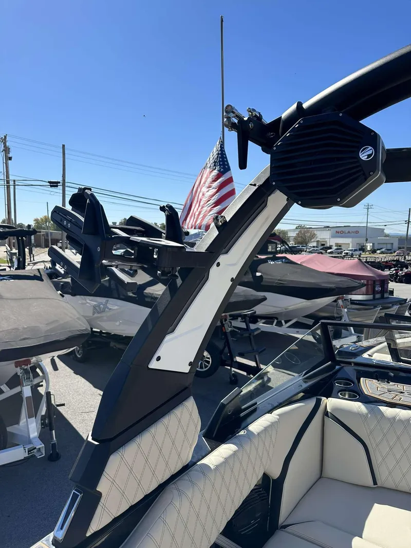 Slide: The Image of 2024 Tigé 24RZX boat with tower speakers and American flag in background. - 26
