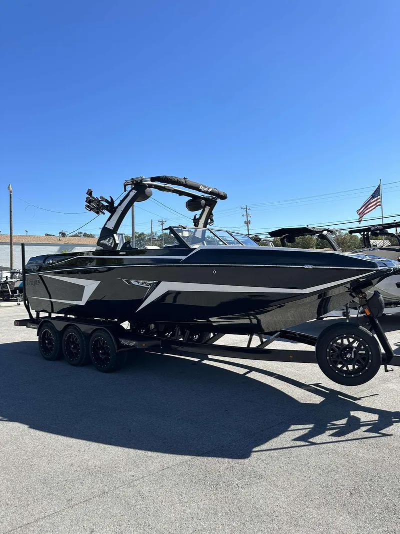 Slide: The Image of 2024 Tigé 24RZX boat on a trailer under a clear blue sky. - 29