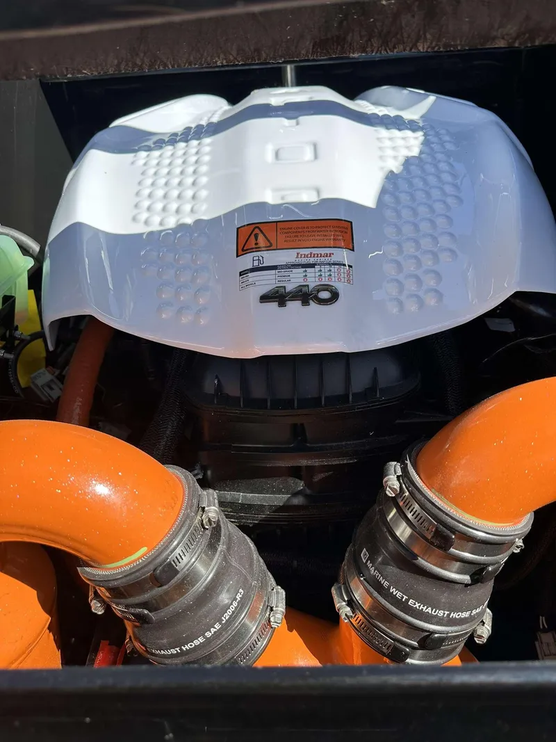 Slide: The Image of 2024 Tigé 24RZX boat engine with orange hoses and white cover. - 35