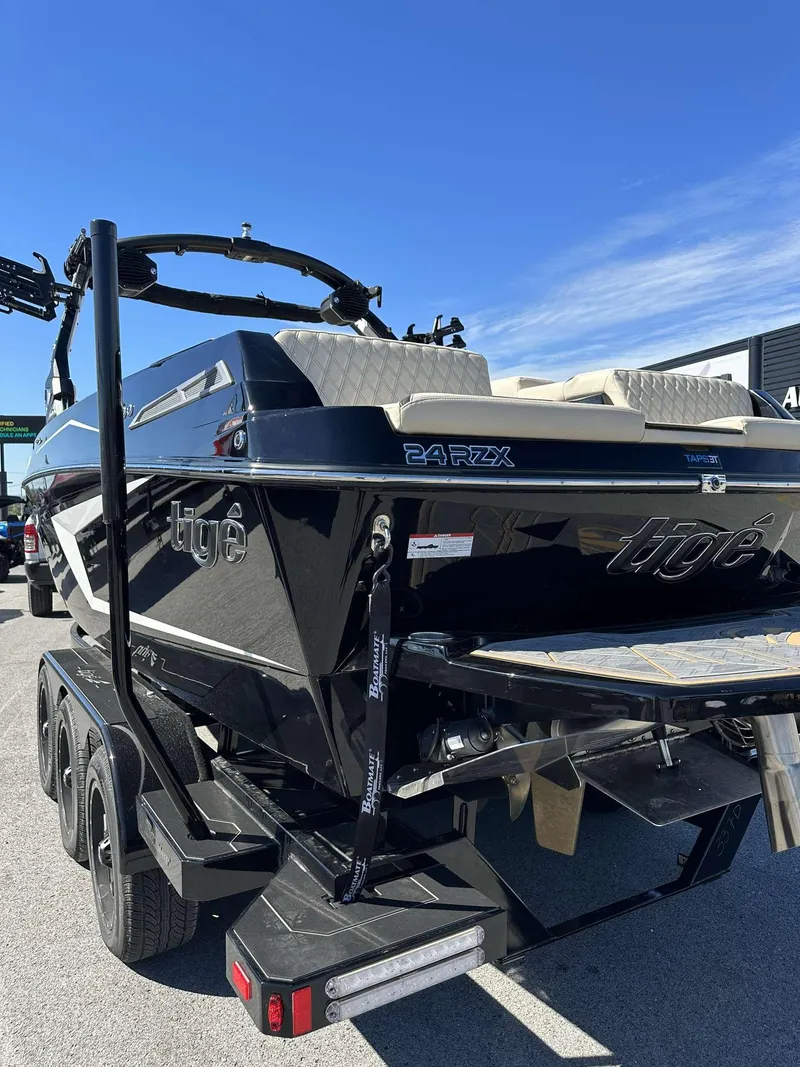 Slide: The Image of 2024 Tigé 24RZX boat, black exterior, rear view on a trailer. - 4
