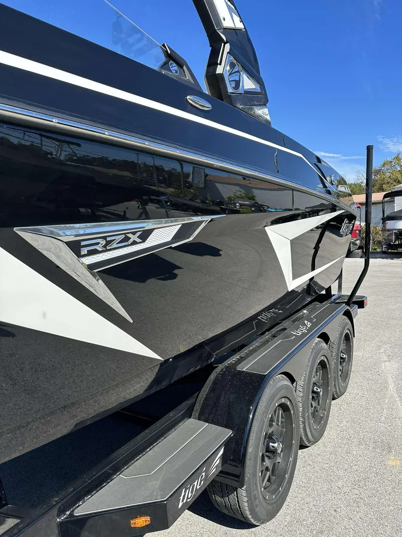 Slide: The Image of 2024 Tigé 24RZX boat on a trailer, side view. - 6