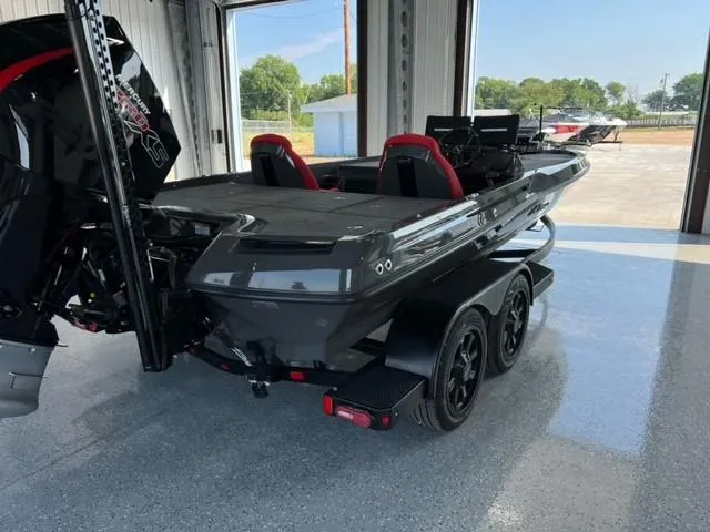 Slide: The Image of 2024 iKon LX21 boat in a garage, featuring dual red seats and a powerful outboard motor. - 11