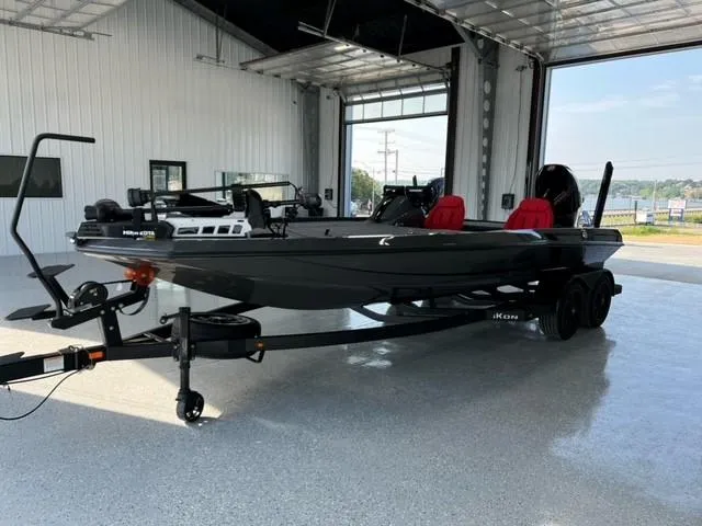 Slide: The Image of 2024 iKon LX21 black fishing boat with red seats in a showroom. - 3