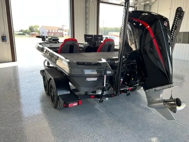 Slide: The Image of 2024 iKon LX21 boat in a garage, rear view with motor and trailer. - 6