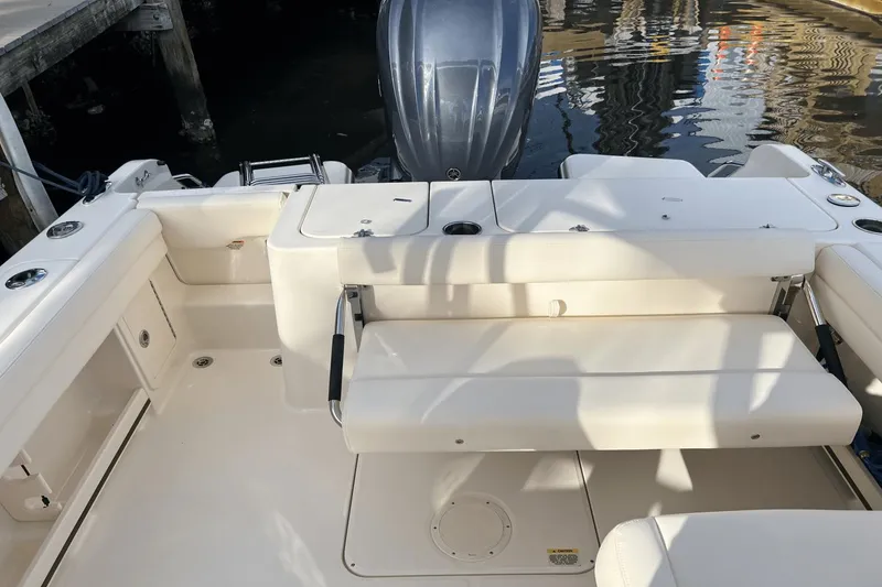 Slide: The Image of 2024 Grady-White Freedom 235 boat interior with seating and outboard motor. - 10
