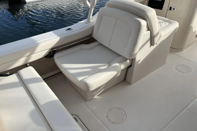 Slide: The Image of 2024 Grady-White Freedom 235 boat interior with white cushioned seating. - 11
