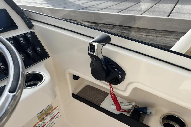 Slide: The Image of 2024 Grady-White Freedom 235 boat control panel and throttle lever. - 19