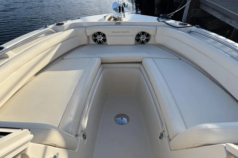 Slide: The Image of 2024 Grady-White Freedom 235 boat interior with cushioned seating and speakers. - 21