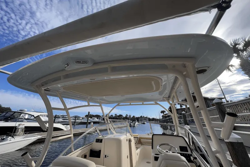 Slide: The Image of 2024 Grady-White Freedom 235 boat interior at marina, clear sky background. - 4
