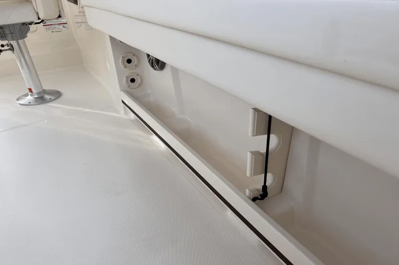 Slide: The Image of Interior detail of 2024 Grady-White Freedom 235 boat, showcasing seating and storage area. - 9